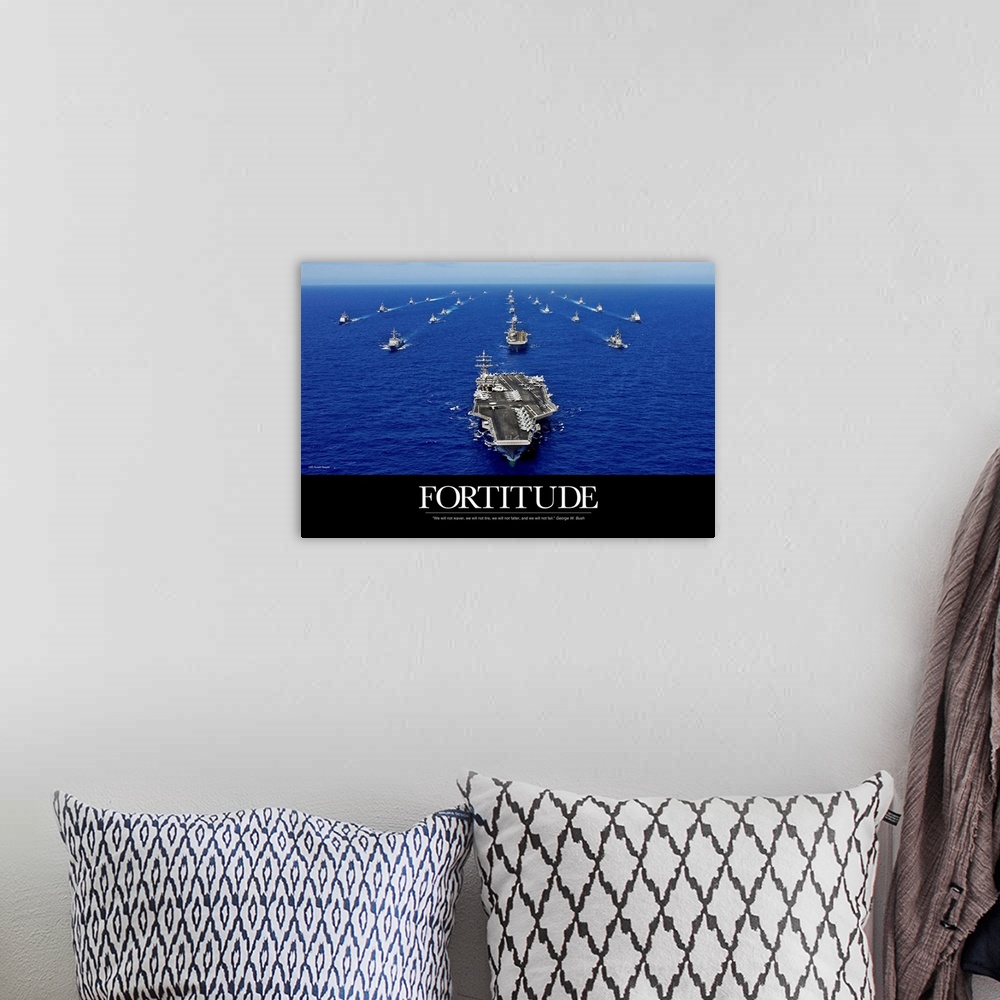 A bohemian room featuring A big piece that is a picture of the navy fleet in the open ocean with the word "Fortitude" below...