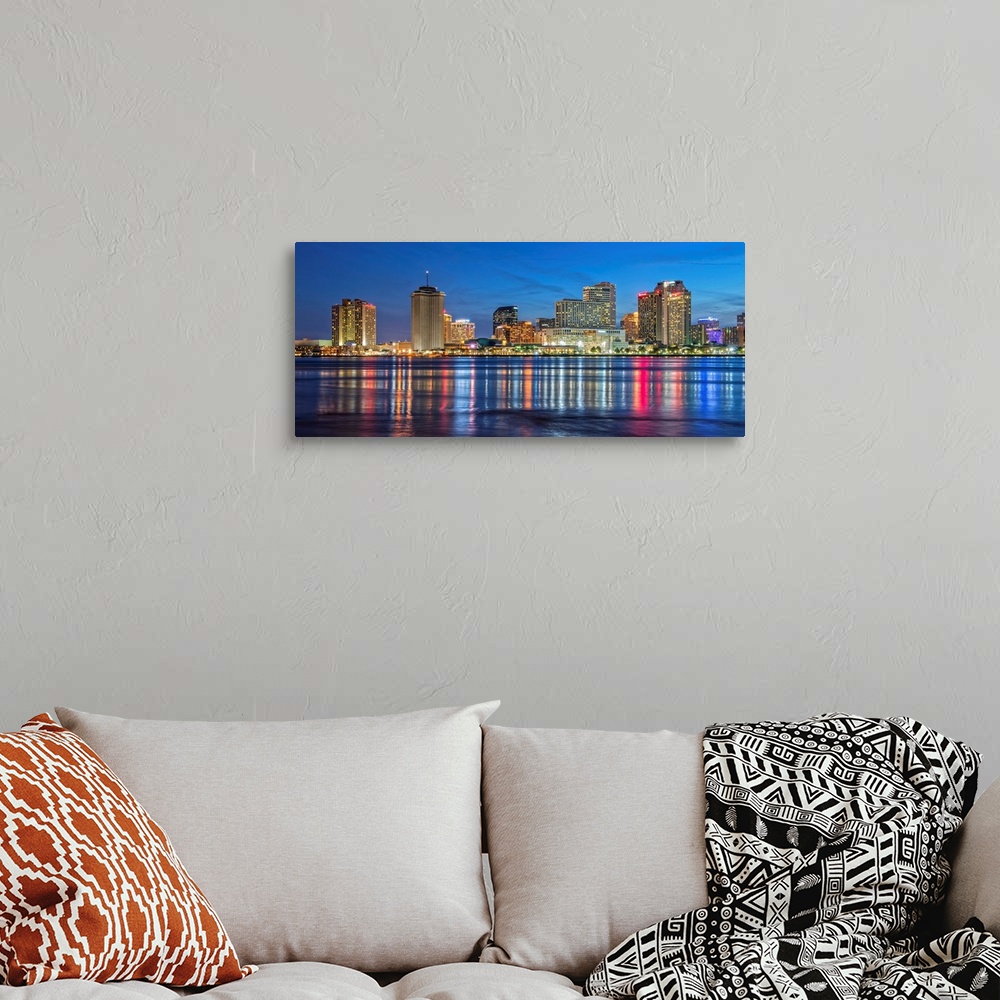 A bohemian room featuring Photograph of the New Orleans skyline lit up at dusk and reflecting colorful bands onto the Missi...