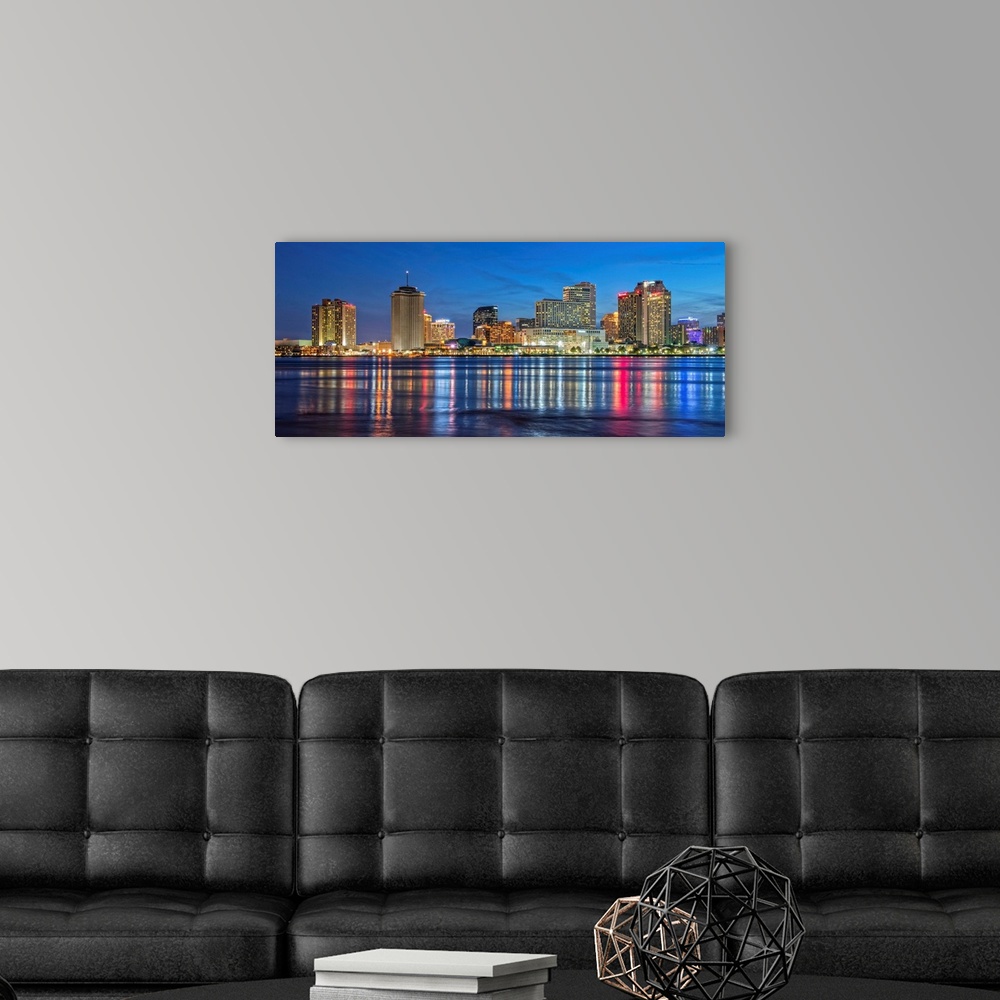 A modern room featuring Photograph of the New Orleans skyline lit up at dusk and reflecting colorful bands onto the Missi...