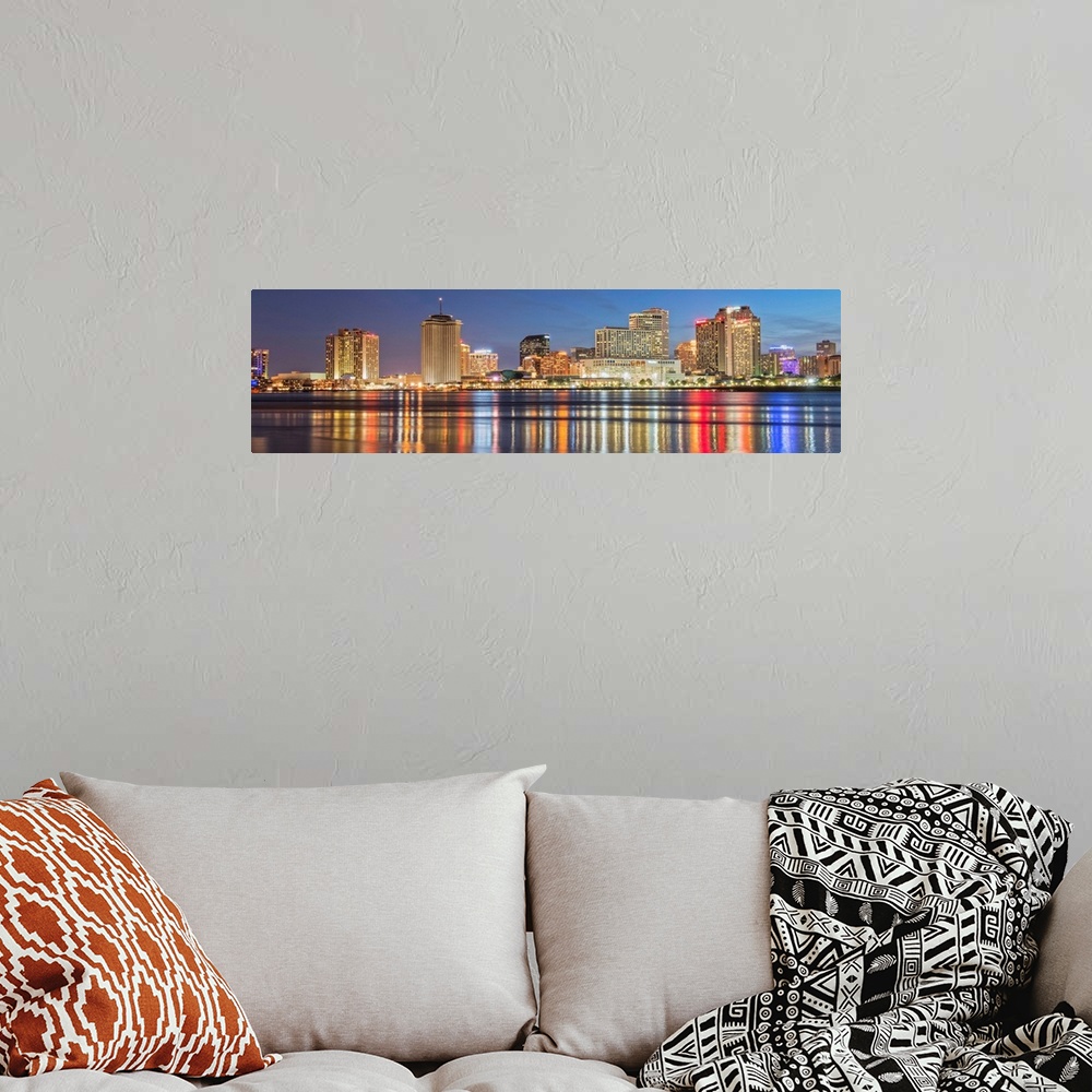 A bohemian room featuring Panoramic photograph of the New Orleans skyline lit up at night and reflecting colorful bands ont...