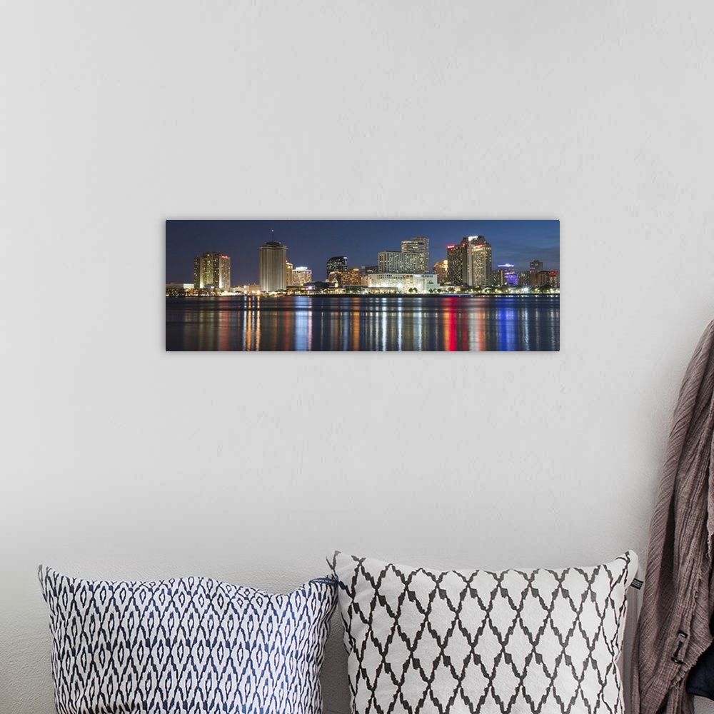A bohemian room featuring Panoramic photograph of the New Orleans skyline lit up at night and reflecting colorful bands ont...