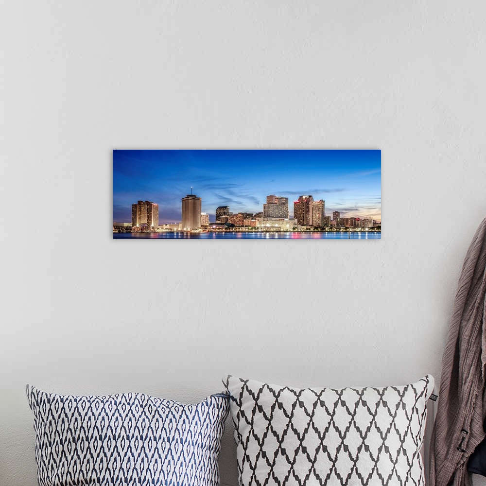 A bohemian room featuring Panoramic photograph of the New Orleans skyline lit up at sunset.