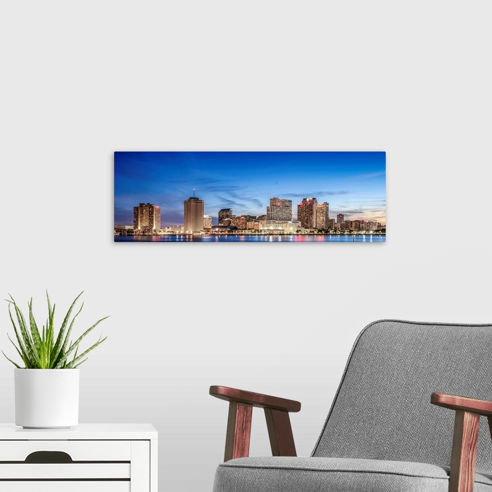 A modern room featuring Panoramic photograph of the New Orleans skyline lit up at sunset.