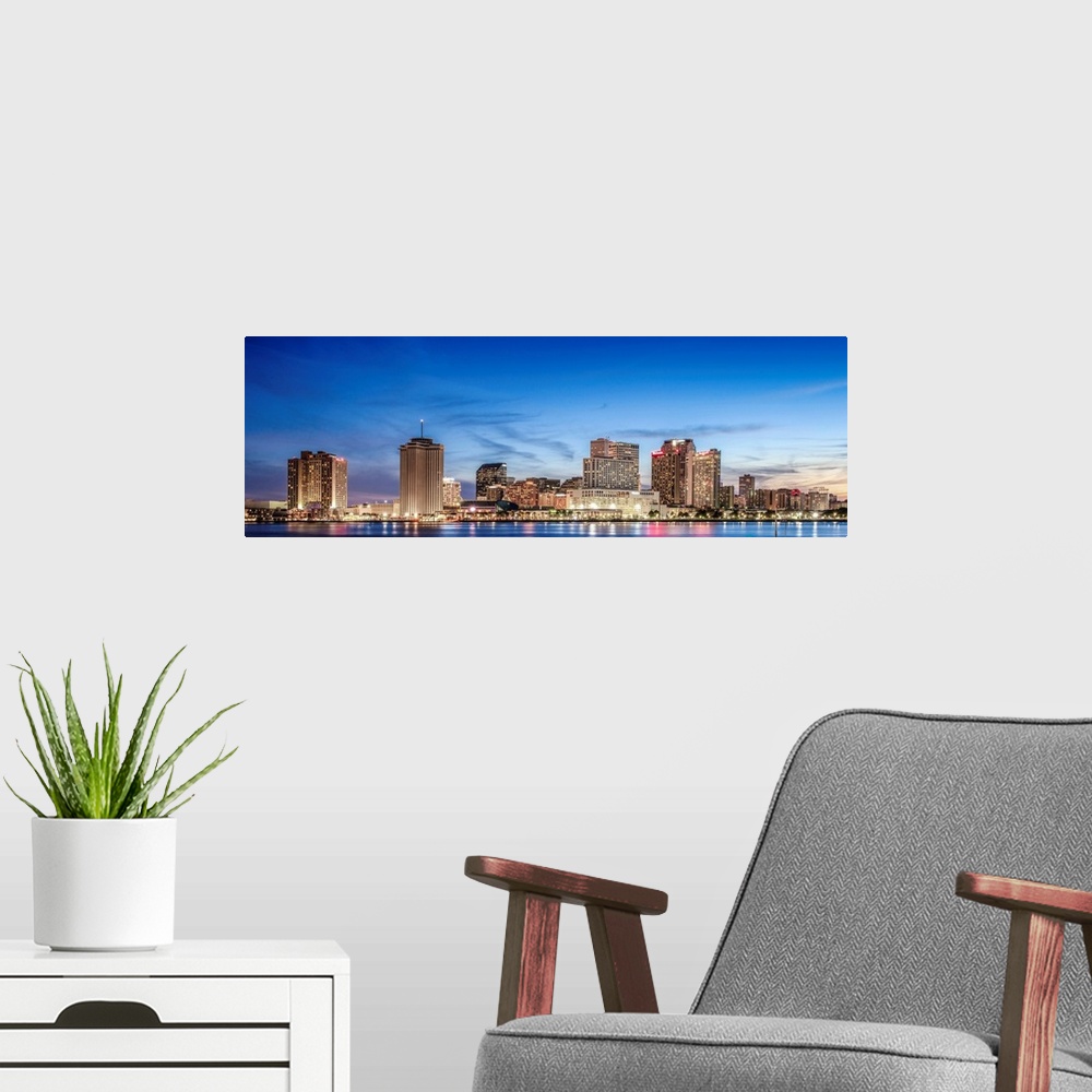 A modern room featuring Panoramic photograph of the New Orleans skyline lit up at sunset.