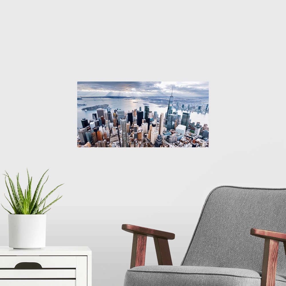 A modern room featuring Aerial view of the skyscrapers in the Financial District at the edge of the water in New York City.