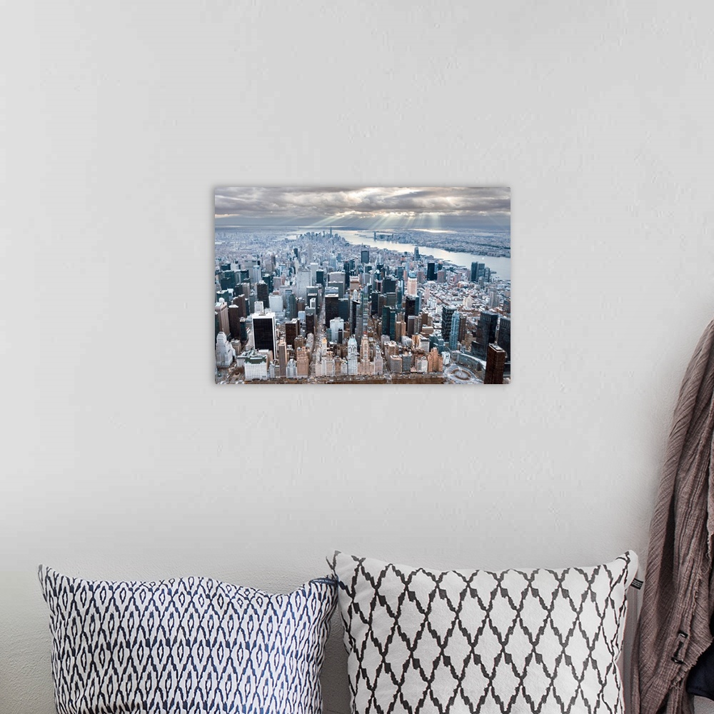 A bohemian room featuring Aerial view of the skyscrapers in New York City, under a cloudy sky.