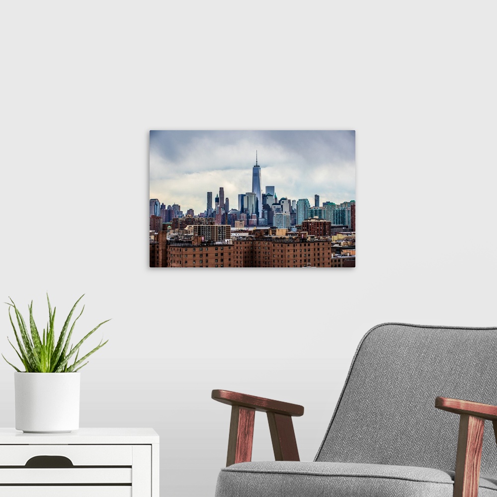 A modern room featuring View of the New York City skyline over Manhattan with cloudy skies.