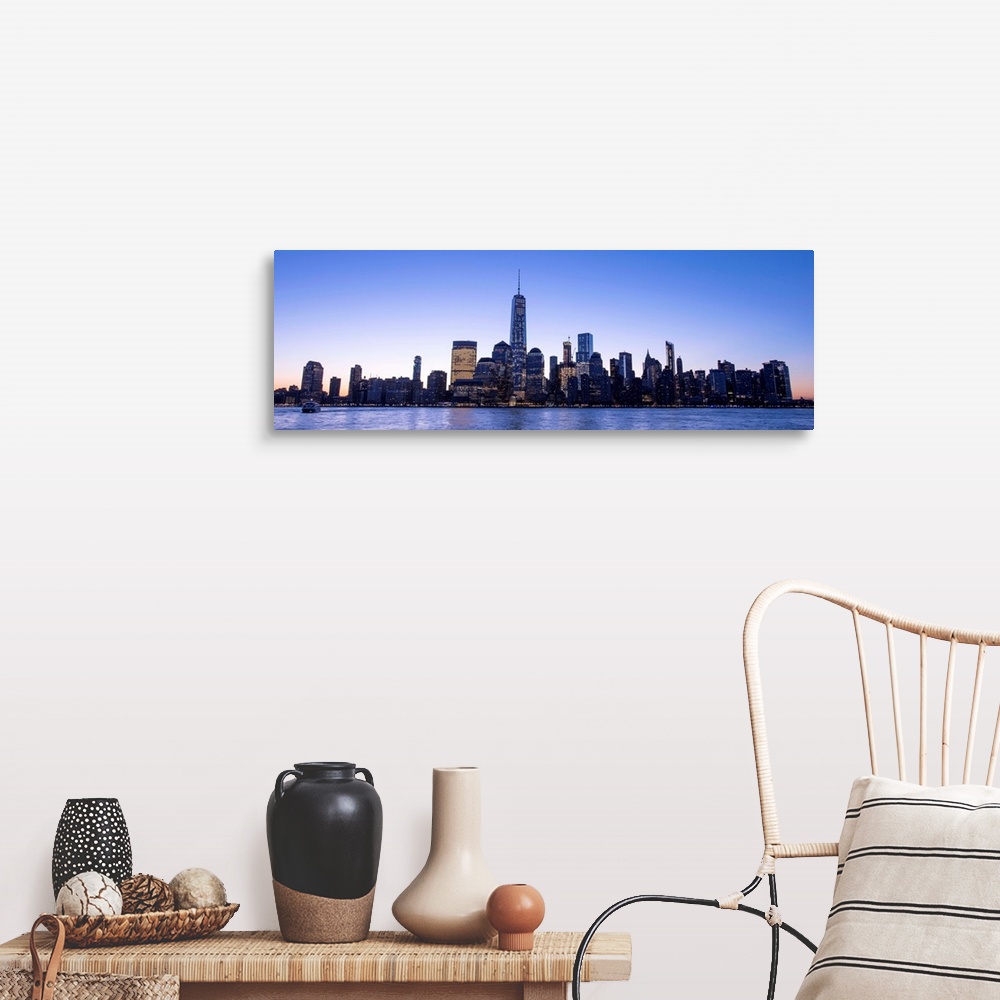 A farmhouse room featuring Panoramic view of the New York City skyline with the One World Trade Center tower, at night.