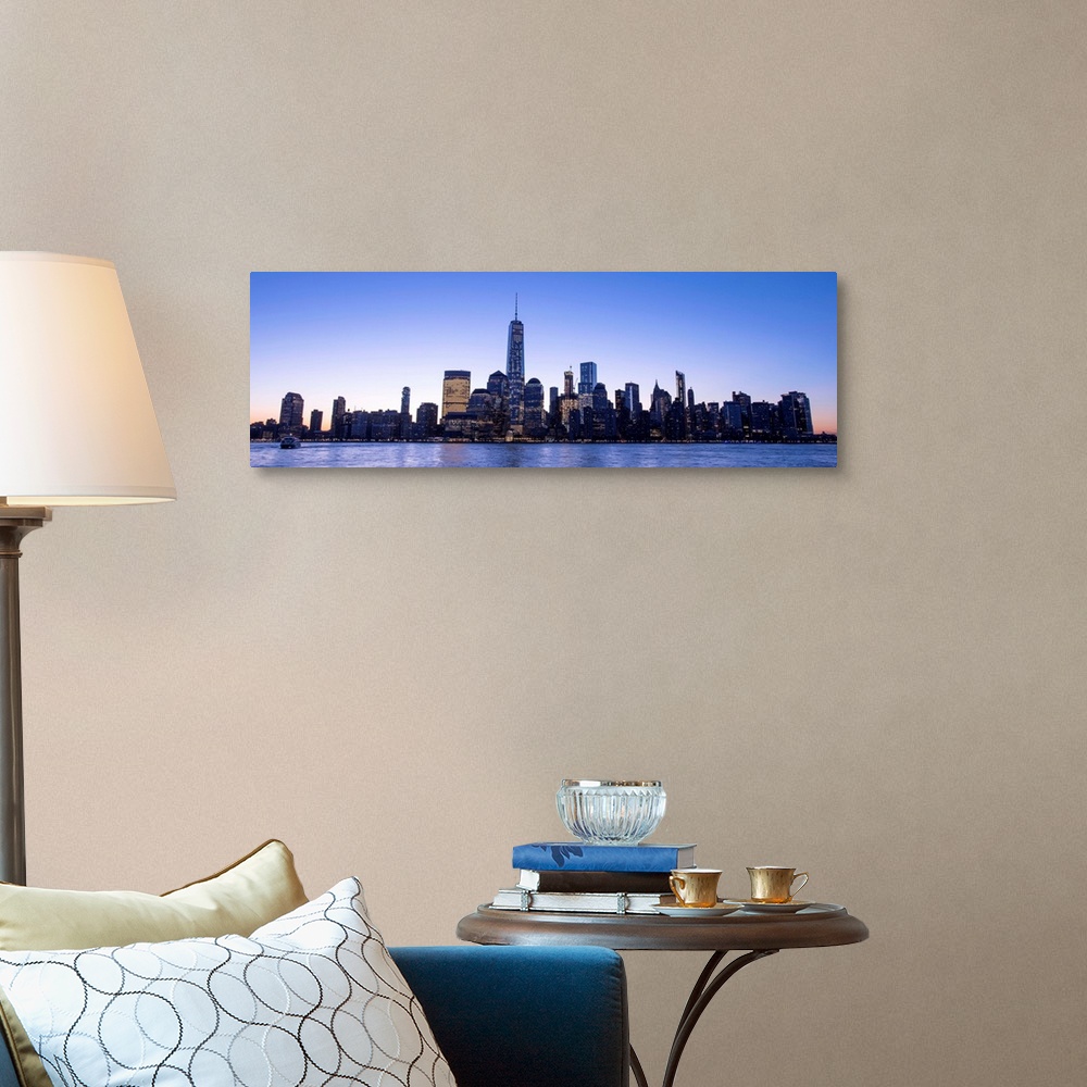A traditional room featuring Panoramic view of the New York City skyline with the One World Trade Center tower, at night.