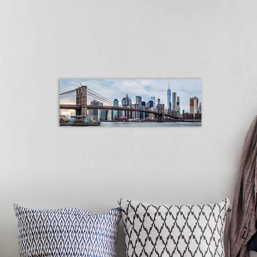 A bohemian room featuring View of the New York City skyline under an overcast sky, with the Brooklyn Bridge, from across th...
