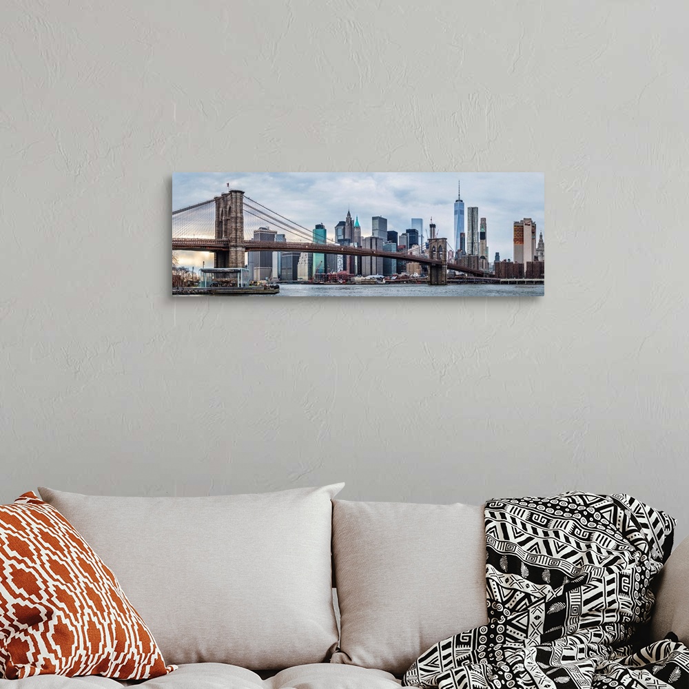 A bohemian room featuring View of the New York City skyline under an overcast sky, with the Brooklyn Bridge, from across th...