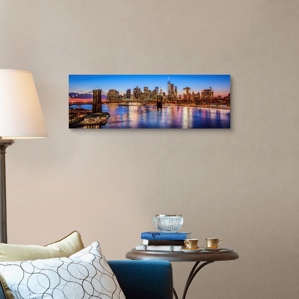 A traditional room featuring View of the New York City skyline illuminated at night, with the Brooklyn Bridge, from across the...