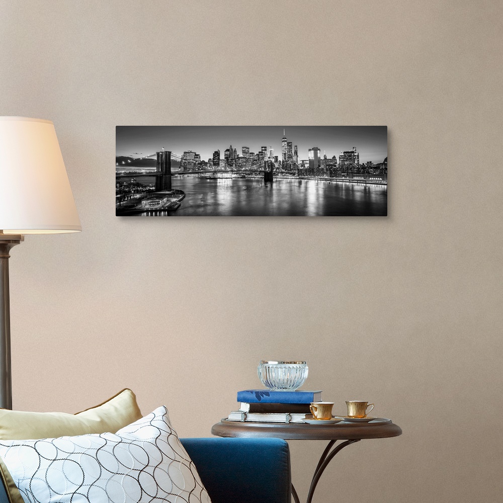 A traditional room featuring View of the New York City skyline illuminated at night, with the Brooklyn Bridge, from across the...