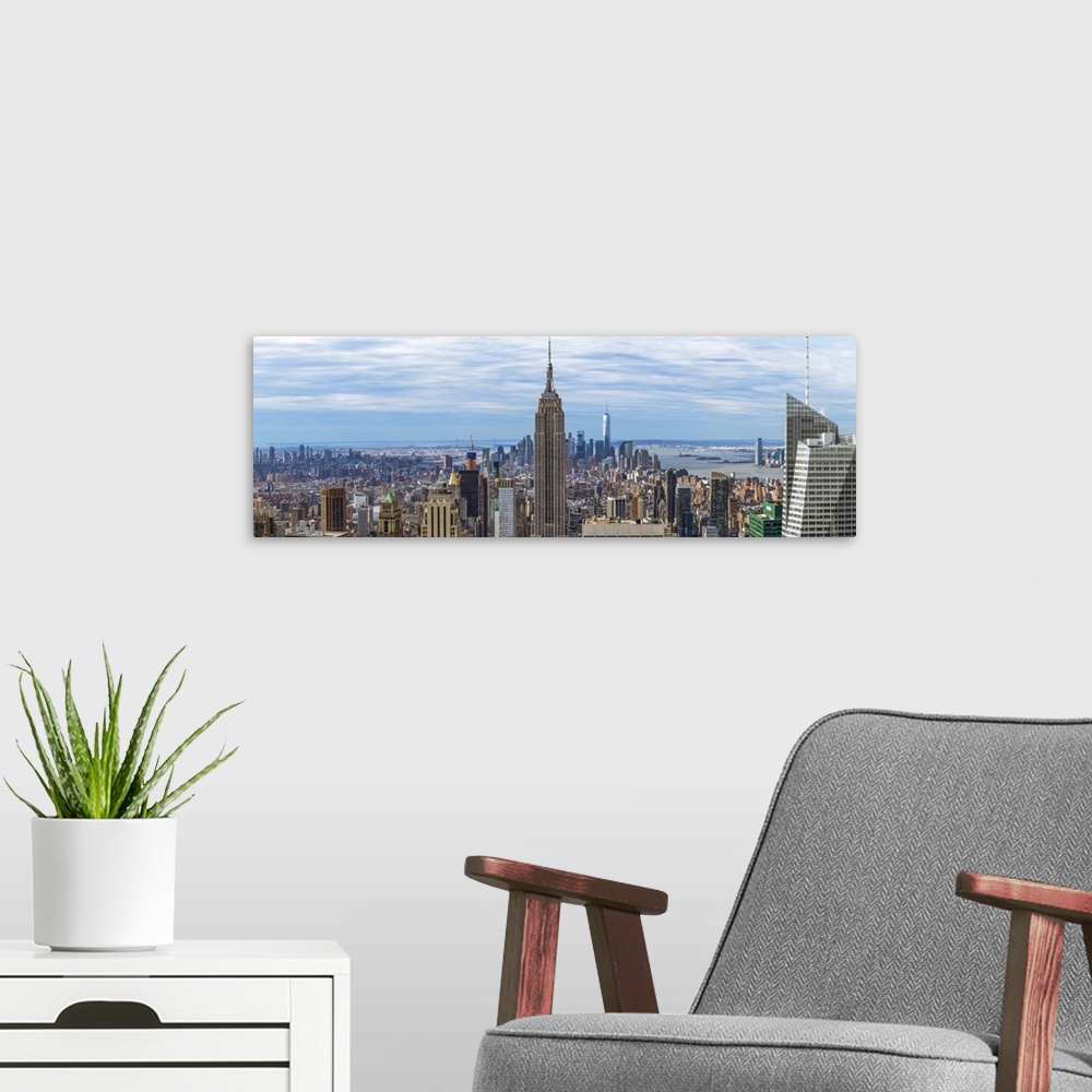 A modern room featuring Panoramic view of New York City with the Empire State Building in the center.
