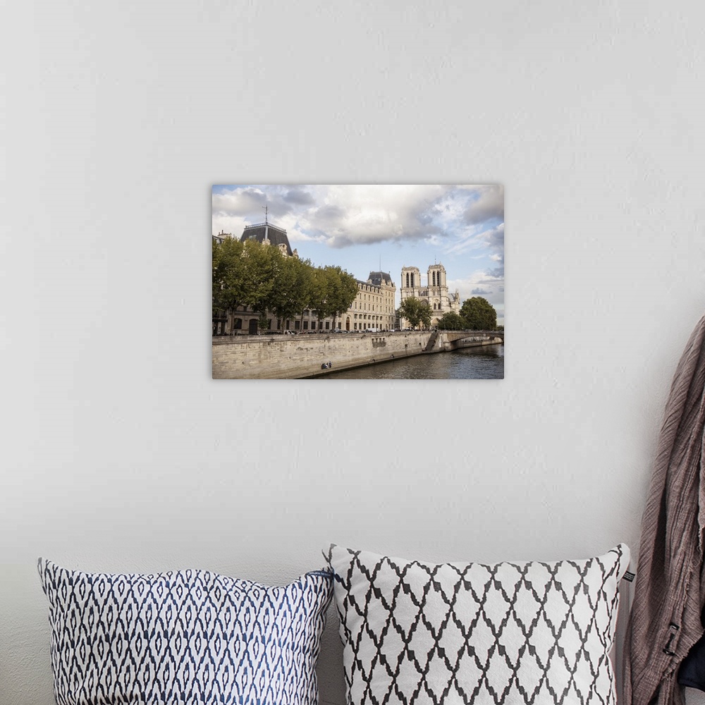 A bohemian room featuring Photograph of the Notre Dame gothic architecture from the water.