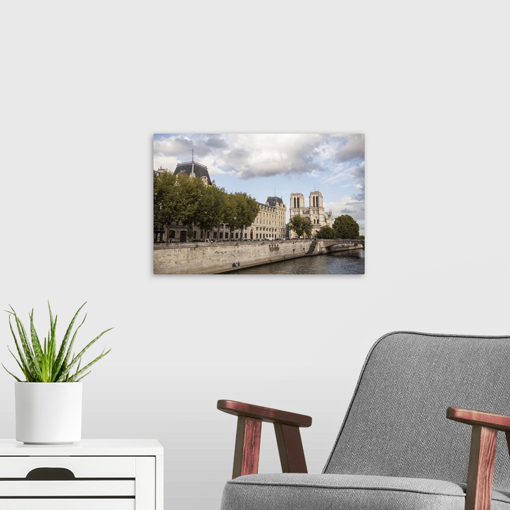 A modern room featuring Photograph of the Notre Dame gothic architecture from the water.