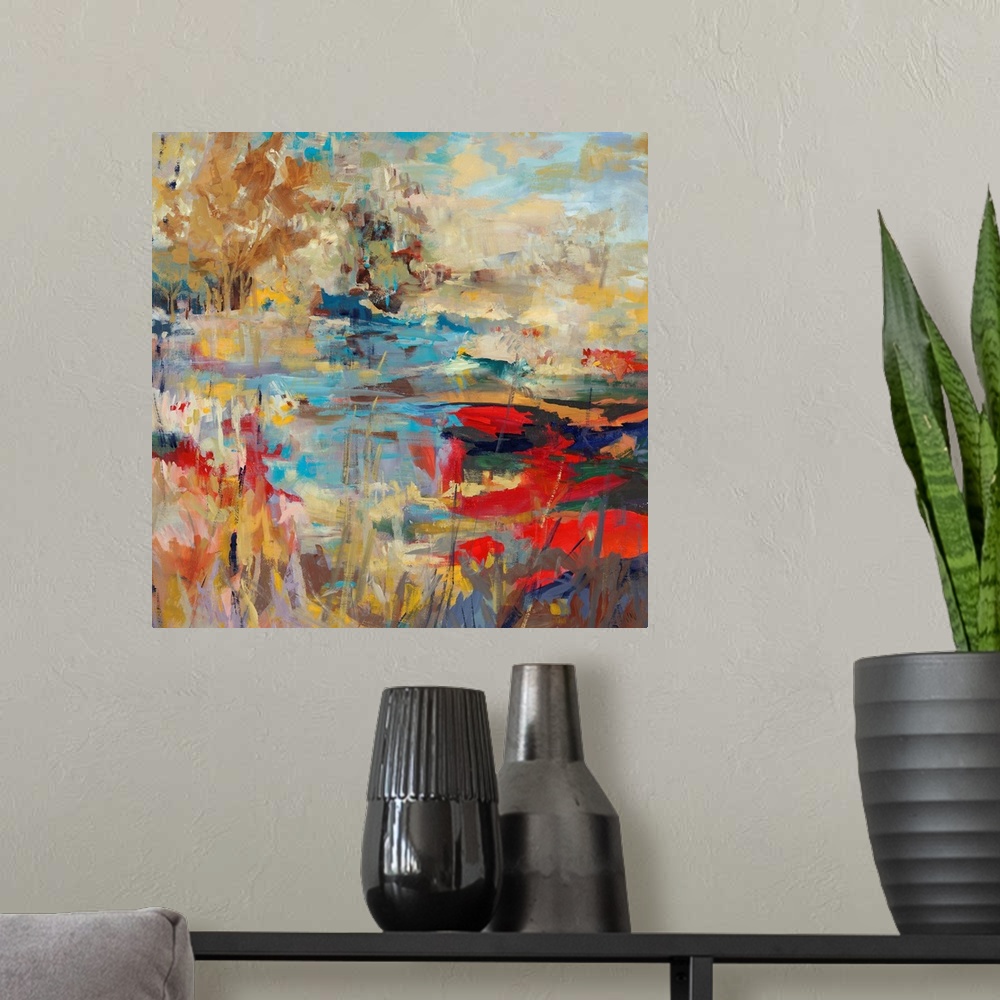 A modern room featuring Abstract landscape painting of a creek with hints of poppy red and bright, mustard yellows.