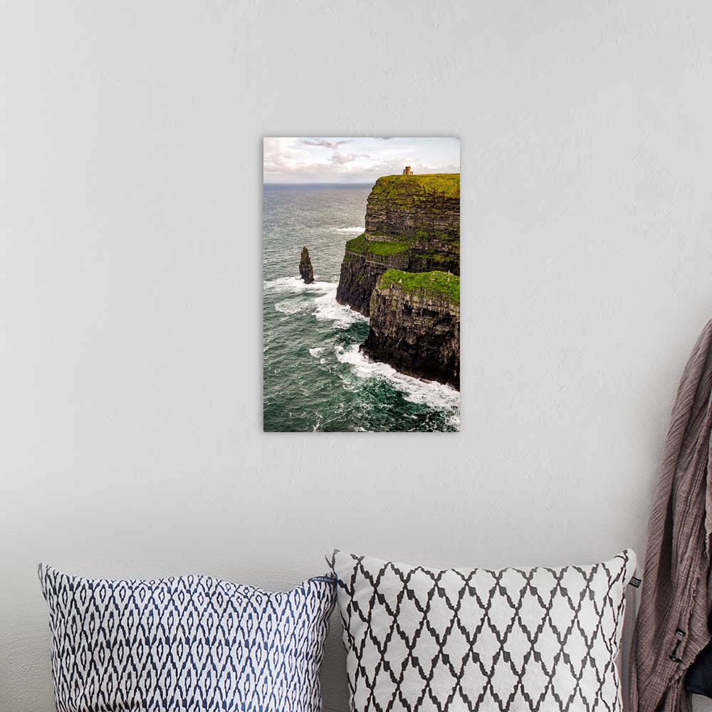 A bohemian room featuring Vertical photograph of O'Brien's Tower, marking the highest point of the Cliffs of Moher in Ireland.