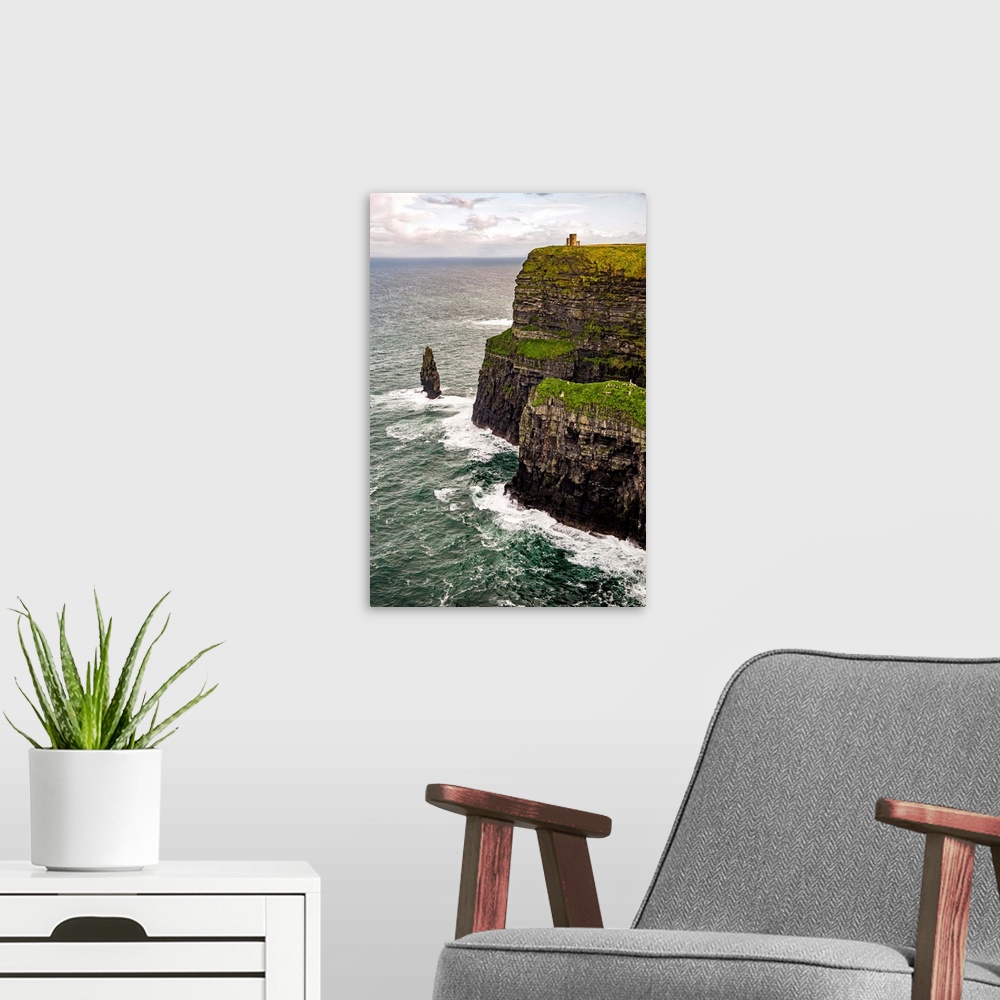 A modern room featuring Vertical photograph of O'Brien's Tower, marking the highest point of the Cliffs of Moher in Ireland.