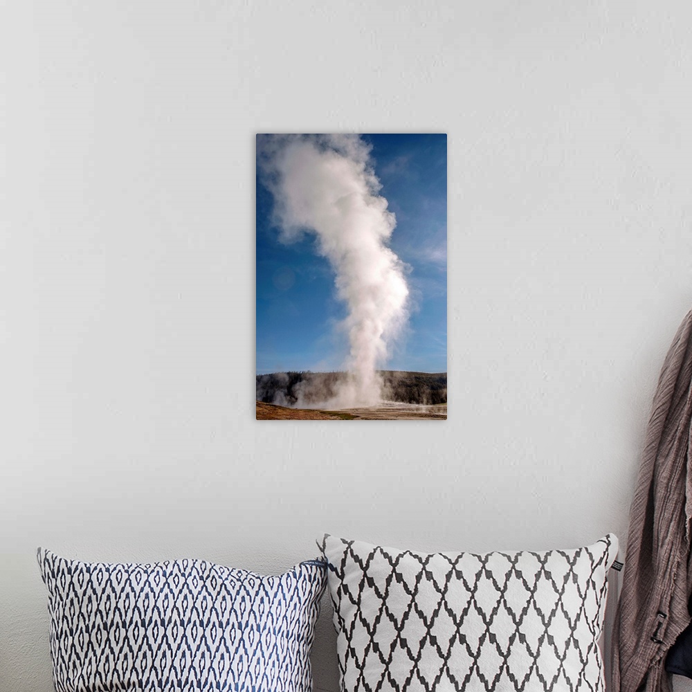 A bohemian room featuring The famous geyser, Old Faithful erupts into a tower of steam at Yellowstone National Park.
