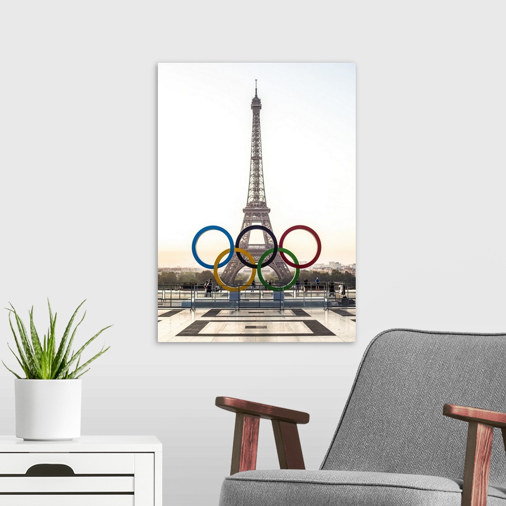 A modern room featuring Photograph of the Eiffel Tower at sunset with the Olympic Rings in front.
