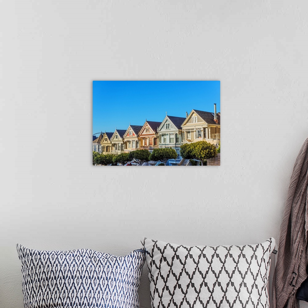 A bohemian room featuring Photograph of the Painted Ladies in downtown San Francisco with a bright blue sky above.