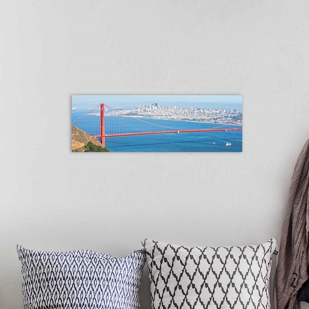 A bohemian room featuring Panoramic photograph of the bright red Golden Gate Bridge with San Francisco in the background.