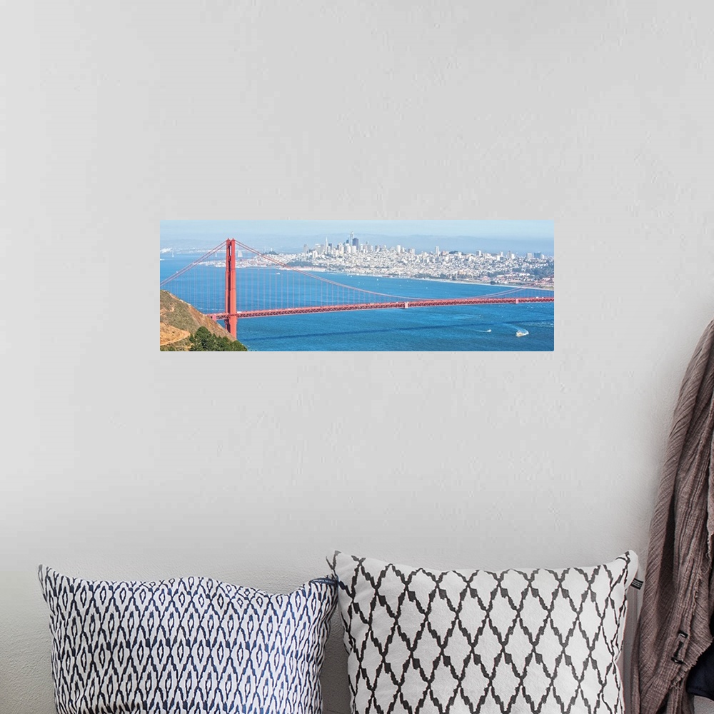 A bohemian room featuring Panoramic photograph of the bright red Golden Gate Bridge with San Francisco in the background.