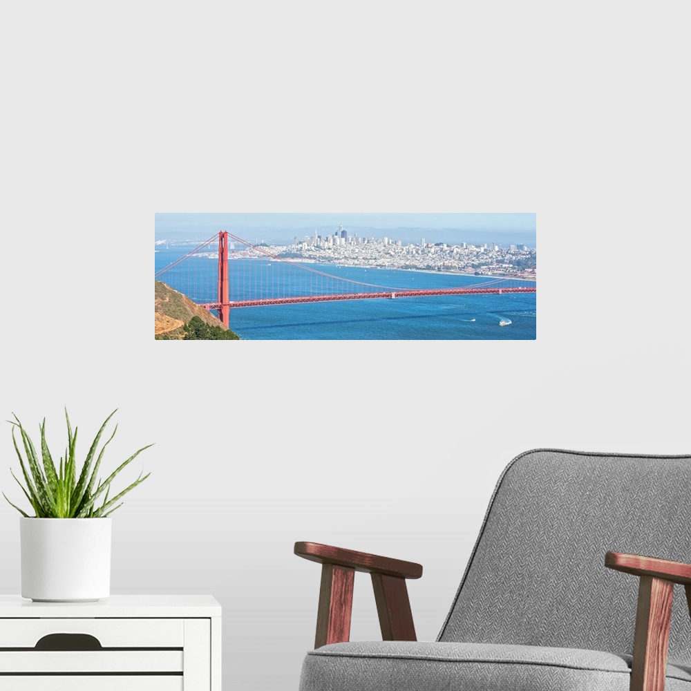 A modern room featuring Panoramic photograph of the bright red Golden Gate Bridge with San Francisco in the background.