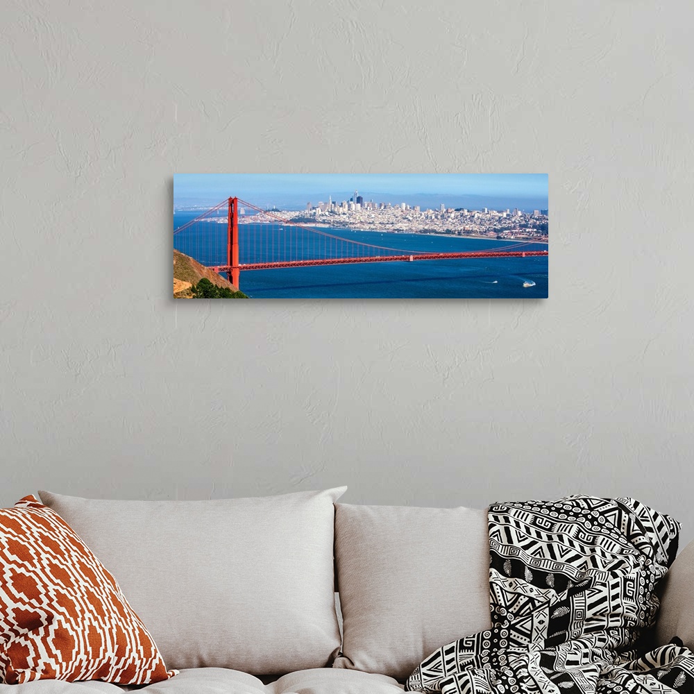 A bohemian room featuring Panoramic photograph of the Golden Gate Bridge with San Francisco's skyscrapers in the background.