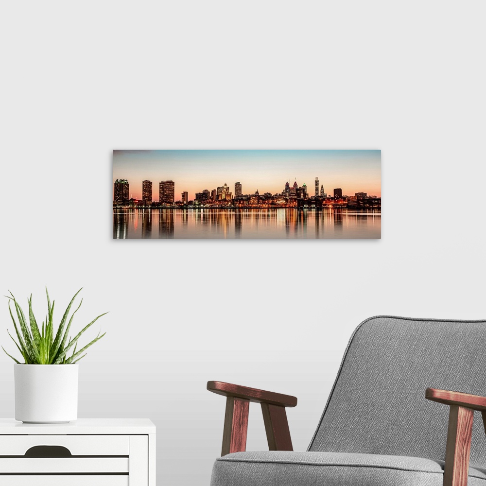 A modern room featuring Panoramic view of Philadelphia City Skyline at Night.