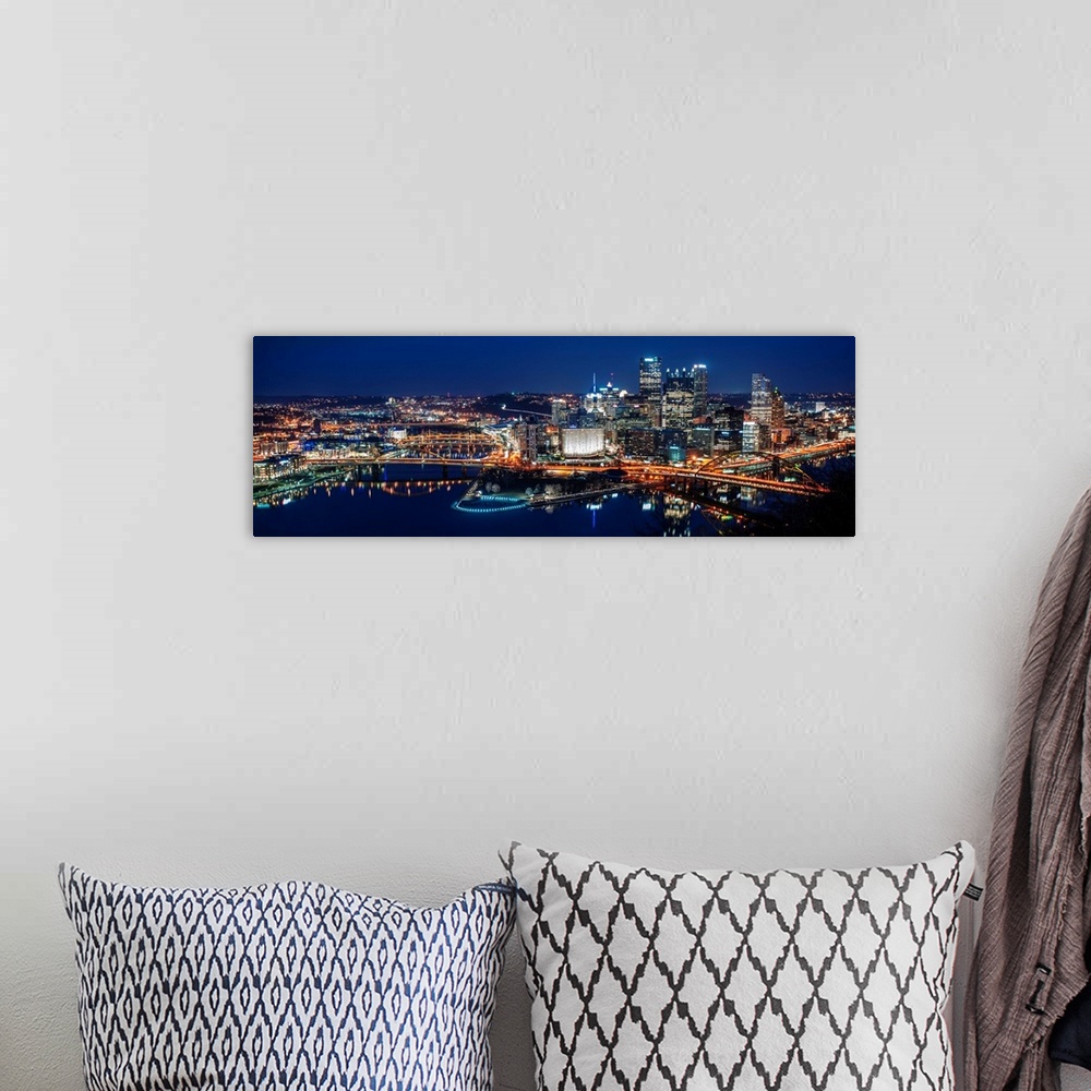 A bohemian room featuring Panoramic photo of downtown Pittsburgh at night with Point State park.