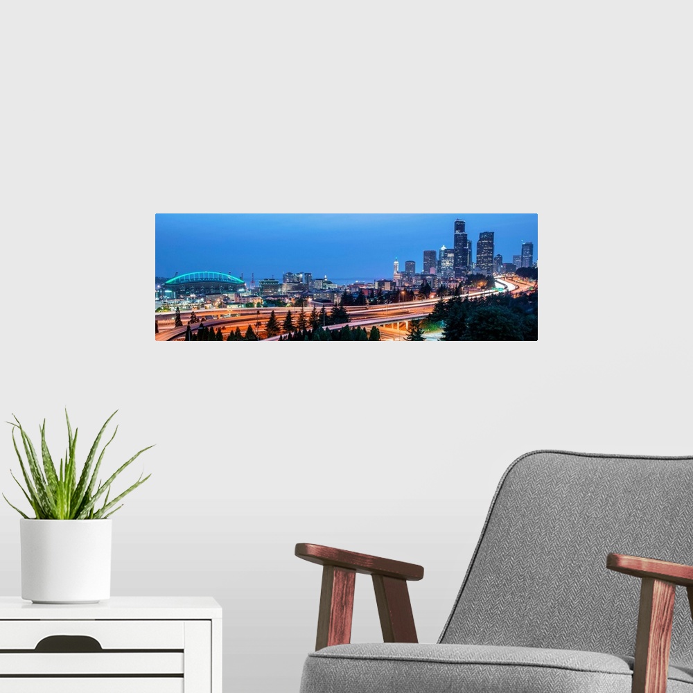 A modern room featuring Panoramic photograph of the Seattle skyline with the stadium on the left and light trails from tr...