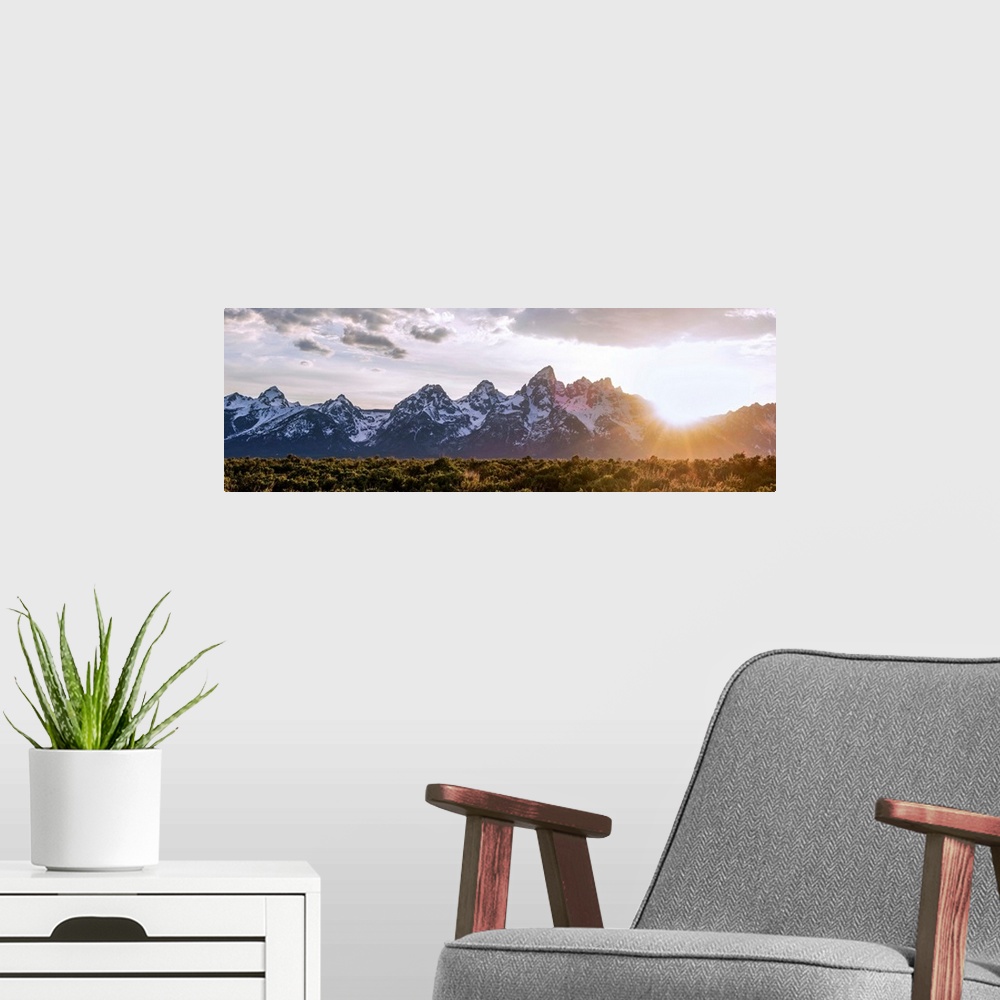 A modern room featuring Panoramic view of the sun rising over Teton mountains in Wyoming.