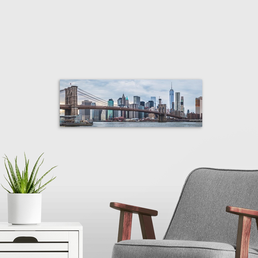 A modern room featuring Panoramic view of New York city skyline with the Brooklyn Bridge.