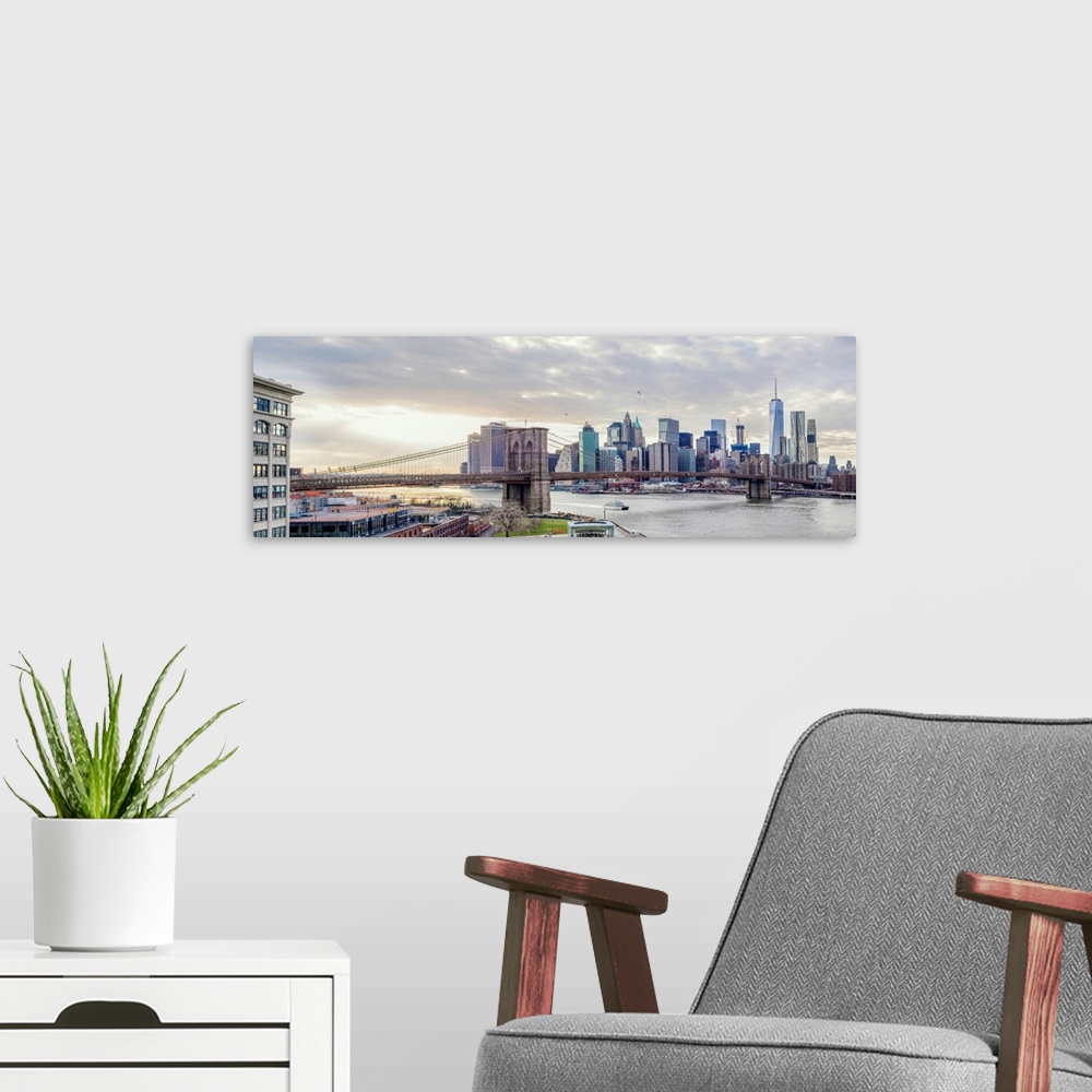 A modern room featuring Panoramic view of the Brooklyn Bridge in New York from the east side with the sun shining through...