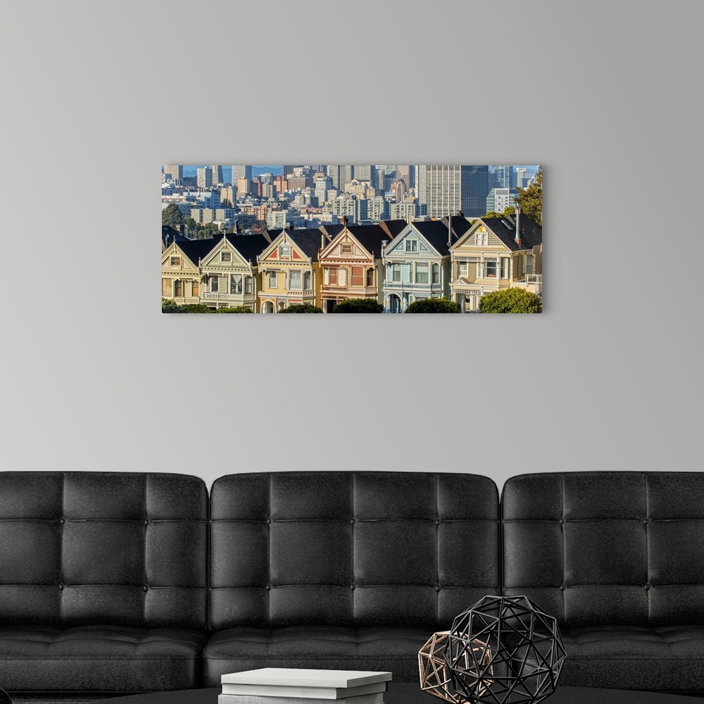 A modern room featuring Panoramic photograph of the Painted Ladies in downtown San Francisco with tall buildings in the b...