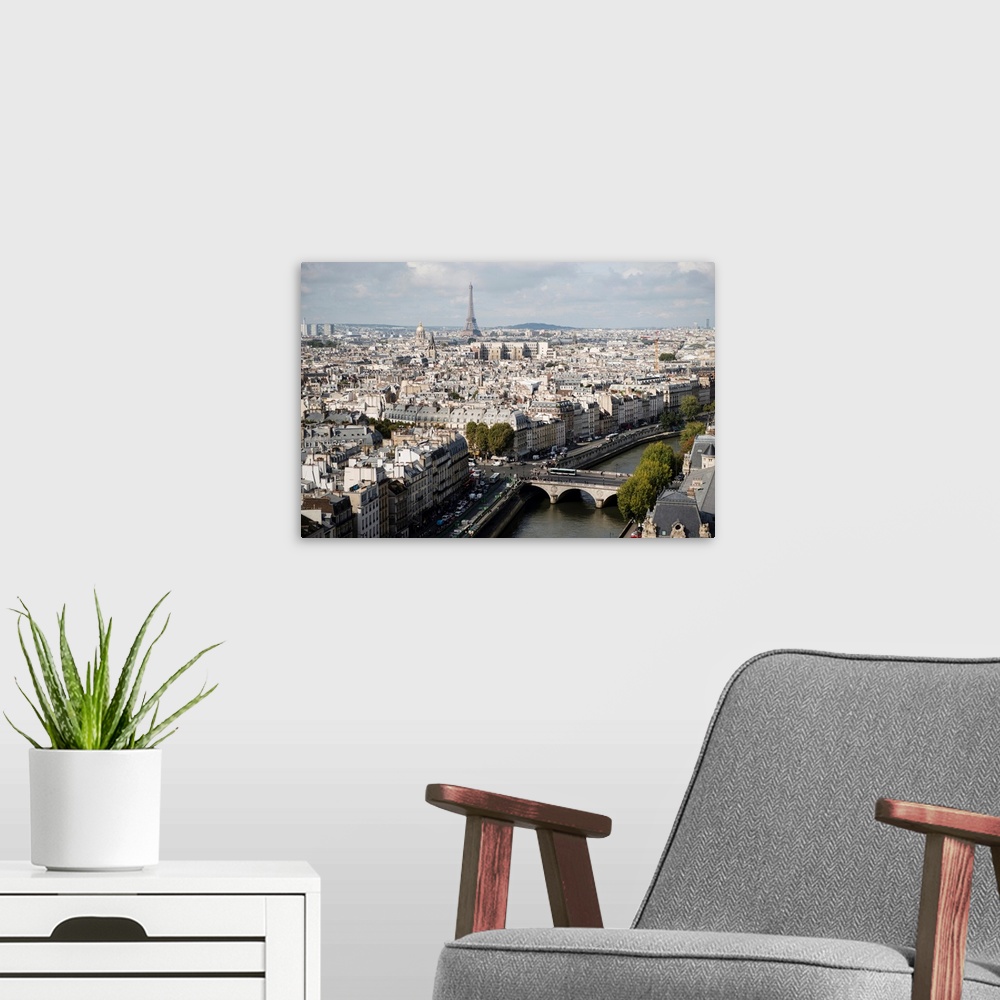 A modern room featuring Photograph of a Paris Cityscape with the Eiffel Tower towering over the city.