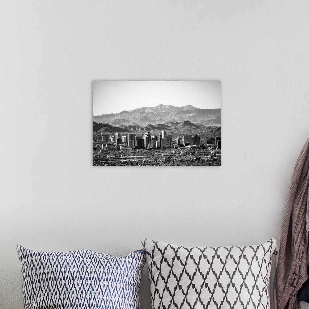 A bohemian room featuring Photograph of the Phoenix, Arizona skyline with hazy desert mountains in the background.