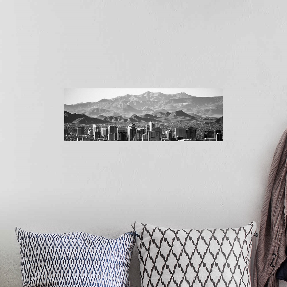 A bohemian room featuring Panoramic photograph of the Phoenix, Arizona skyline with hazy desert mountains in the background.