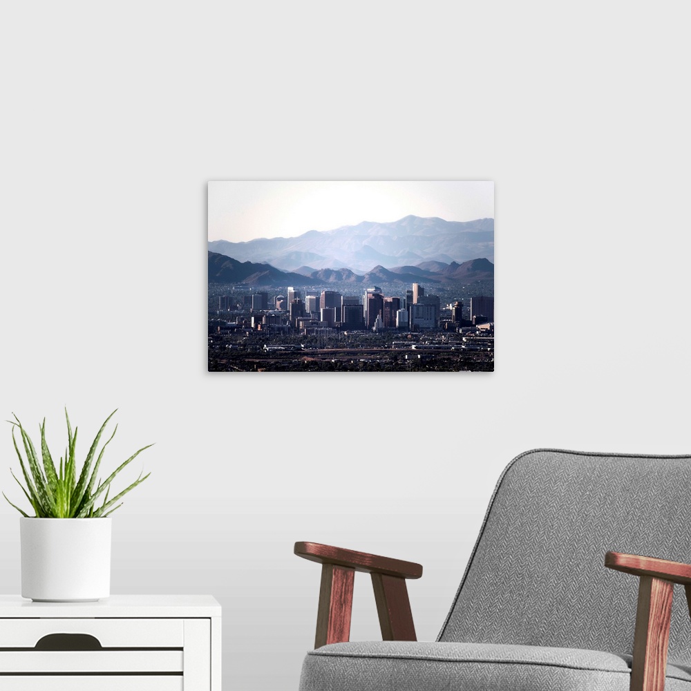 A modern room featuring Photograph of the Phoenix, Arizona skyline with hazy desert mountains in the background.