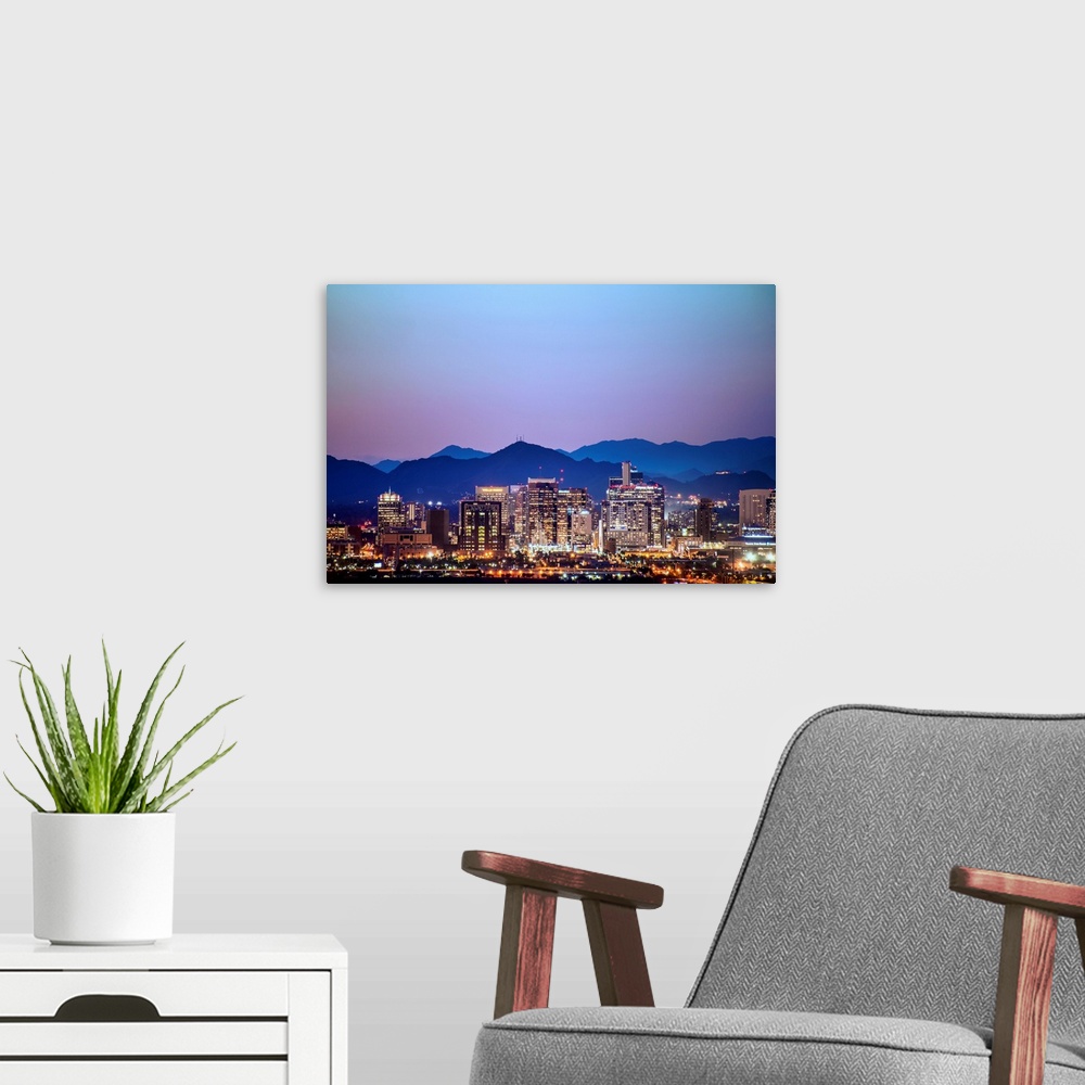 A modern room featuring Photograph of a colorful sunset over the Phoenix, Arizona skyline with silhouetted mountains in t...
