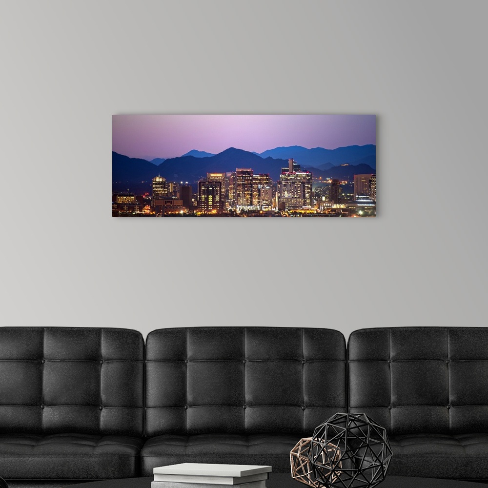 A modern room featuring Panoramic photograph of a colorful sunset over the Phoenix, Arizona skyline with silhouetted moun...