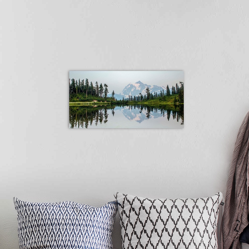 A bohemian room featuring Mount Shuksan is reflected in Picture Lake near Mount Baker, Washington.