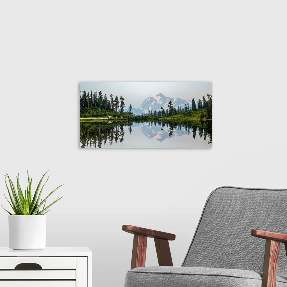 A modern room featuring Mount Shuksan is reflected in Picture Lake near Mount Baker, Washington.