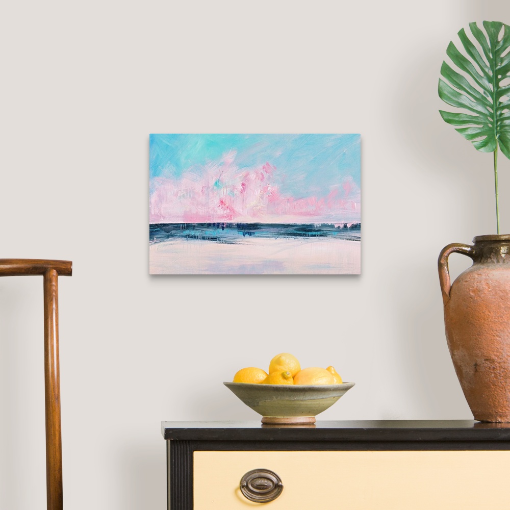A traditional room featuring Semi-abstract contemporary artwork of a seascape with bright pink clouds on the horizon.