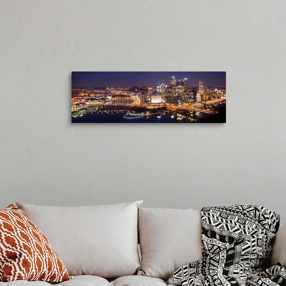 A bohemian room featuring Panoramic photo of the city of Pittsburgh illuminated at night, with Point State Park in the fore...