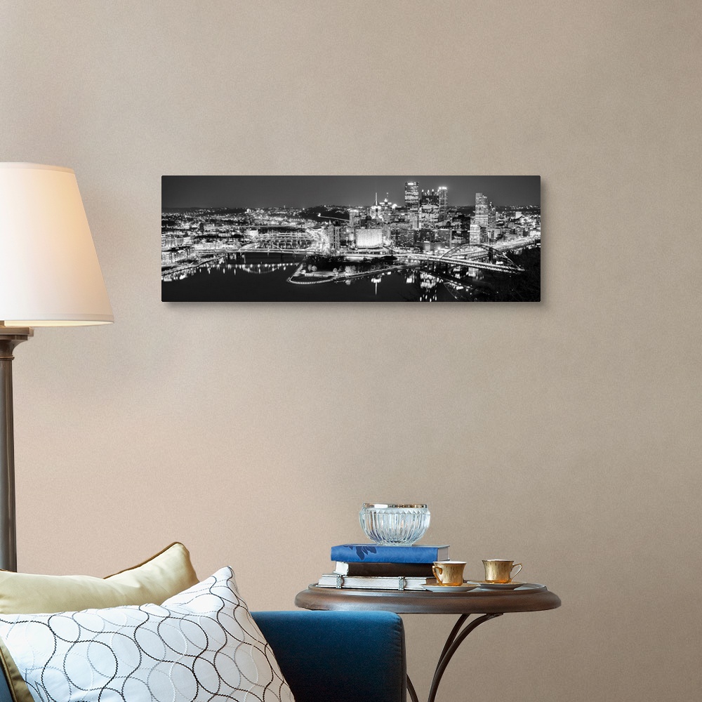 A traditional room featuring Panoramic photo of the city of Pittsburgh illuminated at night, with Point State Park in the fore...