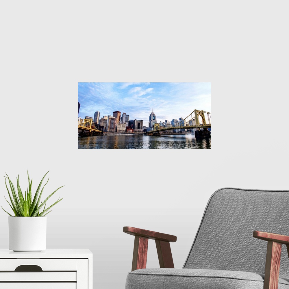 A modern room featuring Photo of downtown Pittsburgh with Roberto Clemente Bridge over the Allegheny River.