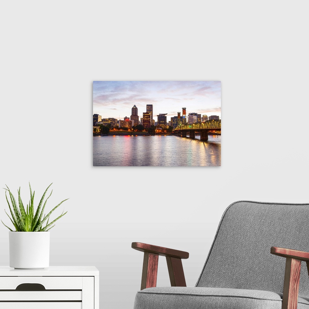 A modern room featuring Photograph of the Portland, Oregon skyline lit up at sunset with yellow lights and a small cresce...